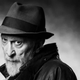A black-and-white photograph of comic book writer-artist Frank Miller.